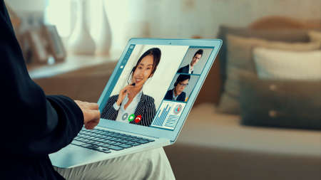 Video call business people meeting on virtual workplace or remote office. Telework conference call using smart video technology to communicate colleague in professional corporate business.の写真素材