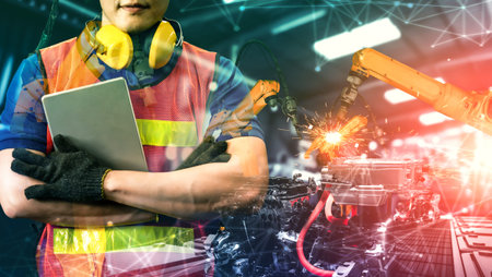 Mechanized industry robot arm and factory worker double exposure . Concept of robotics technology...