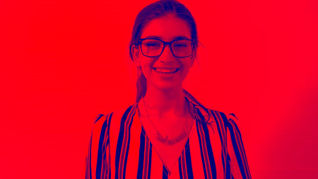 Duotone or half tone portrait of young caucasian woman in studio looking at camera