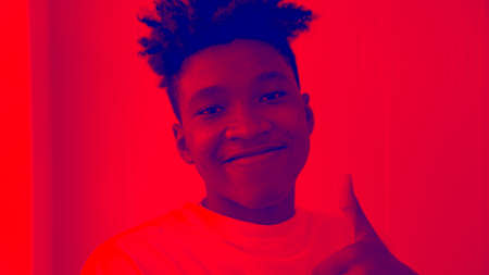 Duotone or half tone portrait of young african american man in studio looking at cameraの写真素材