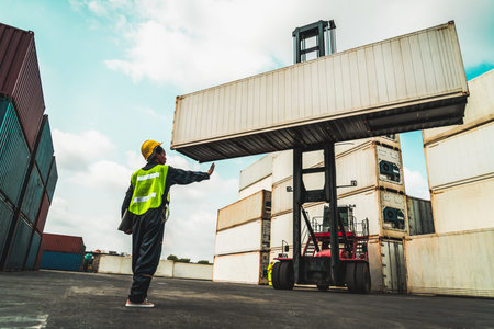 Young African American woman worker at overseas shipping container yard . Logistics supply chain...