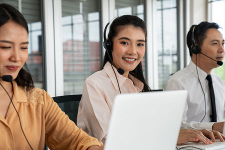 Business people wearing headset working actively in office . Call center, telemarketing, customer...