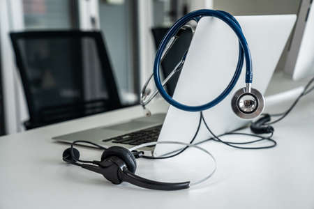 Headset and doctor equipment at clinic ready for actively support for patient by online video call . Concept of telehealth and telemedicine service .の写真素材