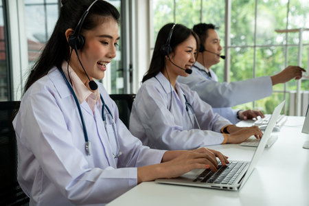 Doctor team wearing headset talking actively on video call in hospital clinic . Concept of telehealth and telemedicine service .の写真素材