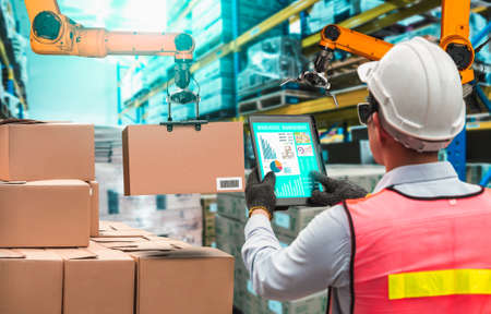 Smart robot arm systems for innovative warehouse and factory digital technology . Automation manufacturing robot controlled by industry engineering using IOT software connected to internet network .の写真素材
