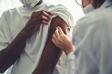Young man visits skillful doctor at hospital for vaccination . Covid 19 and coronavirus vaccination...