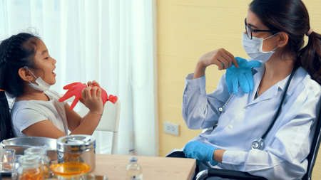 School girl visits skillful doctor at hospital for vaccination . Covid 19 and coronavirus vaccination center service concept .の写真素材