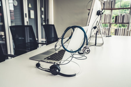 Headset and doctor equipment at clinic ready for actively support for patient by online video call . Concept of telehealth and telemedicine service .の写真素材