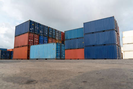 Cargo container for overseas shipping in shipyard with heavy machine . Logistics supply chain management and international goods export concept .の写真素材