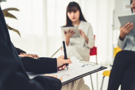 Businesswoman in business meeting writing paper proficiently at office room . Corporate business team collaborationの写真素材