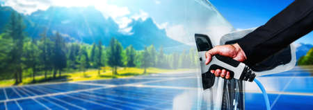 EV charging station for electric car in concept of green energy and eco power produced from sustainable source to supply to charger station in order to reduce CO2 emission .の写真素材