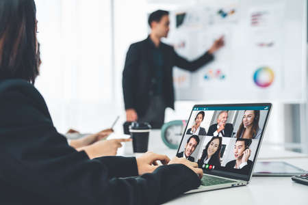 Business people in video call meeting proficiently discuss business plan in office and virual workplace . Telework conference call using smart video technology to communicate colleague .の写真素材