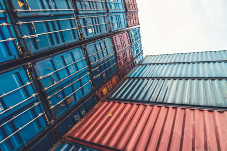 Cargo container for overseas shipping on high stack look up from ground . Logistics supply chain management and international goods export concept .の写真素材