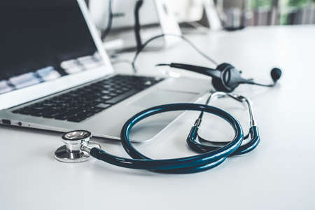 Headset and doctor equipment at clinic ready for actively support for patient by online video call . Concept of telehealth and telemedicine service .の写真素材