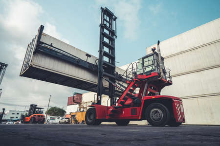 Cargo container for overseas shipping in shipyard with heavy machine . Logistics supply chain management and international goods export concept .の写真素材