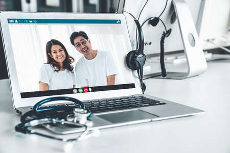 Telemedicine service online video call for doctor to actively chat with patient via remote healthcare consultant software . People can use app to contact doctors for virtual meeting from home .の写真素材