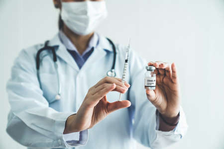 Skillful doctor prepare vaccine proficiently before injection . Covid 19 and coronavirus vaccination center service concept .の写真素材
