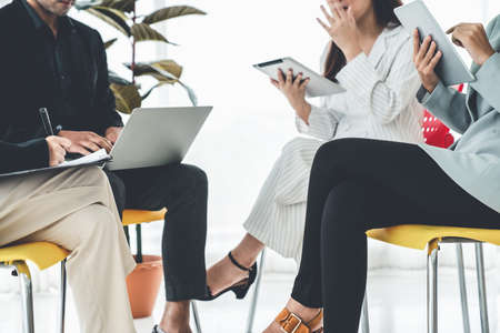 Business people proficiently discuss work project while sitting in circle . Corporate business team collaboration concept .の写真素材
