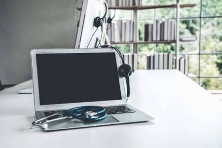 Headset and doctor equipment at clinic ready for actively support for patient by online video call . Concept of telehealth and telemedicine service .の写真素材