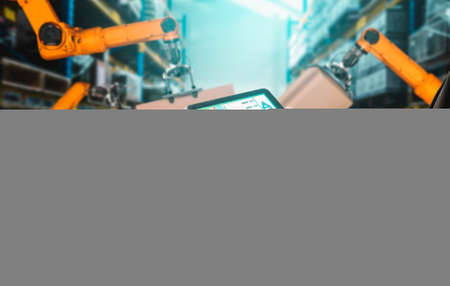 Smart robot arm systems for innovative warehouse and factory digital technology . Automation manufacturing robot controlled by industry engineering using IOT software connected to internet network .の写真素材