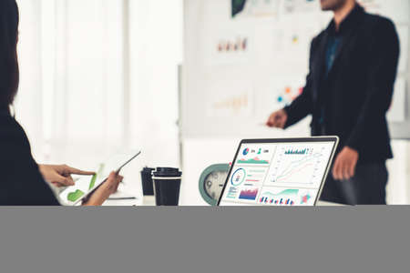 Businesswoman in business meeting using laptop computer proficiently at office for marketing data analysis . Corporate business team collaboration concept .の写真素材