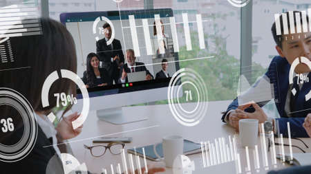 Creative visual of business people in a corporate staff meeting on video call . Concept of digital technology for marketing data analysis and investment decision making .の写真素材