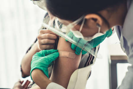Young woman visits skillful doctor at hospital for vaccination .の写真素材