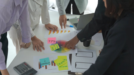 Business people proficiently discuss work project on meeting table . Corporate business team collaboration concept .の写真素材