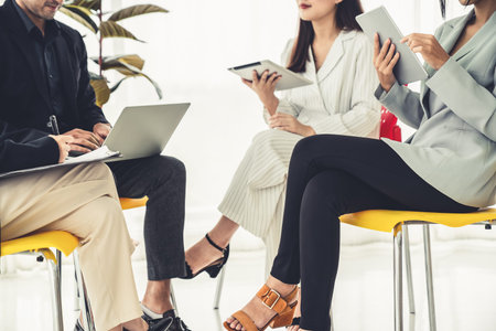 Business people proficiently discuss work project while sitting in circle . Corporate business team...