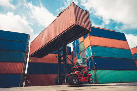 Cargo container for overseas shipping in shipyard with heavy machine . Logistics supply chain management and international goods export concept .の写真素材