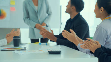Businesswoman proficiently present work project receive celebrations from team . Corporate business team collaboration concept .の写真素材
