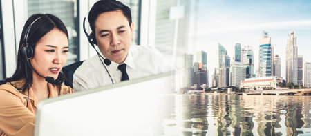 Business team wearing headset working actively in office . Call center, telemarketing, customer...