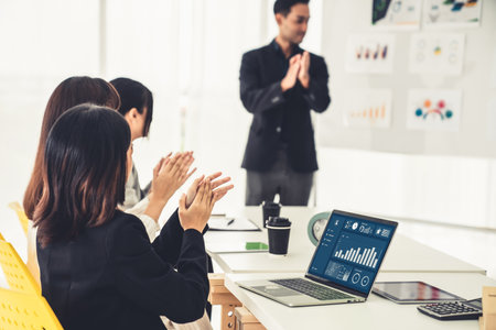 Businesswoman in business meeting using laptop computer proficiently at office for marketing data analysis . Corporate business team collaboration concept .の写真素材