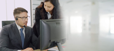 Business people wearing headset working in office to support remote customer or colleague. Call...