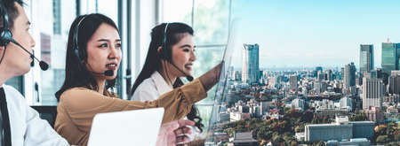 Business team wearing headset working actively in office . Call center, telemarketing, customer support agent provide service on telephone video conference call.の写真素材