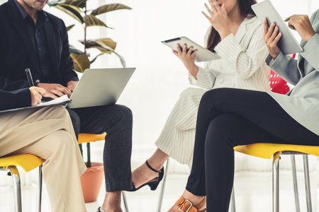 Business people proficiently discuss work project while sitting in circle . Corporate business team collaboration concept .の写真素材
