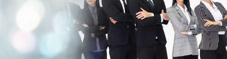 Successful business people standing together showing strong relationship of worker community. A team of businessman and businesswoman expressing a strong group teamwork at office broaden viewの写真素材
