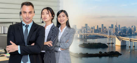 Business people wearing headset working in office to support remote customer or colleague. Call center, telemarketing, customer support agent provide service in broaden view .の写真素材