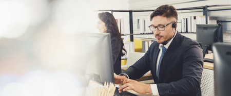 Business people wearing headset working in office to support remote customer or colleague. Call...