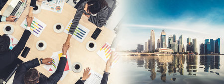 Group business people handshake at meeting table in office together with confident shot from top view . Young businessman and businesswoman workers express agreement of investment deal. broaden viewの写真素材