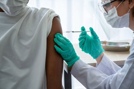 Young man visits skillful doctor at hospital for vaccination . Virus vaccination center service concept .の写真素材