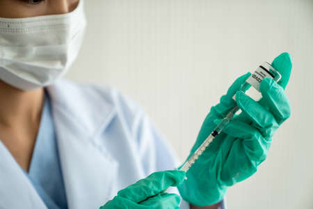 Skillful doctor prepare vaccine proficiently before injection .  Virus vaccination center service concept .の写真素材