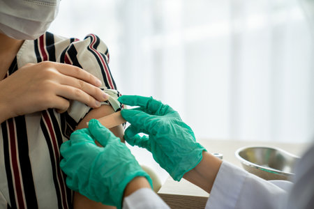 Young woman visits skillful doctor at hospital for vaccination .Virus vaccination center service concept .の写真素材