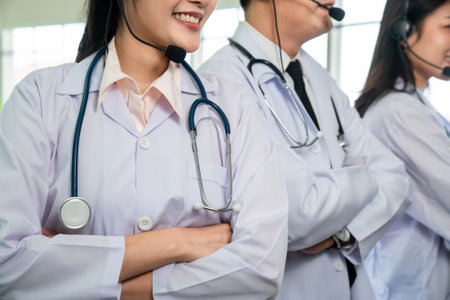 Doctor team wearing headset talking actively on video call in hospital clinic . Concept of telehealth and telemedicine service .の写真素材