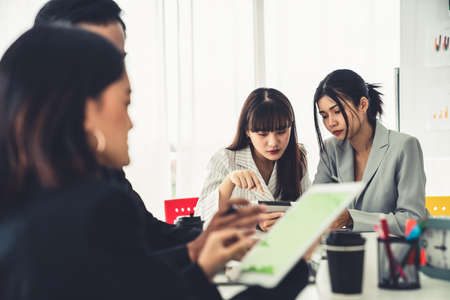 Businesswoman in business meeting using computer proficiently at office room . Corporate business team collaboration concept .の写真素材