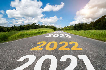 2022 New Year road trip travel and future vision concept . Nature landscape with highway road leading forward to happy new year celebration in the beginning of 2022 for fresh and successful start .の写真素材