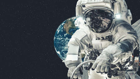 Astronaut spaceman do spacewalk while working for spaceflight mission at space station . Astronaut wear full spacesuit for operation .の写真素材