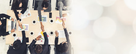 Group business people handshake at meeting table in office together with confident shot from top...