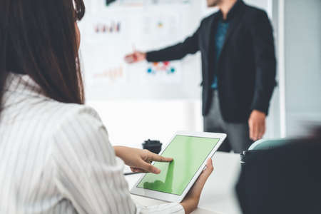 Businesswoman in business meeting using computer proficiently at office room . Corporate business team collaboration concept .の写真素材