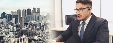 Business people wearing headset working in office to support remote customer or colleague. Call center, telemarketing, customer support agent provide service in broaden view .の写真素材